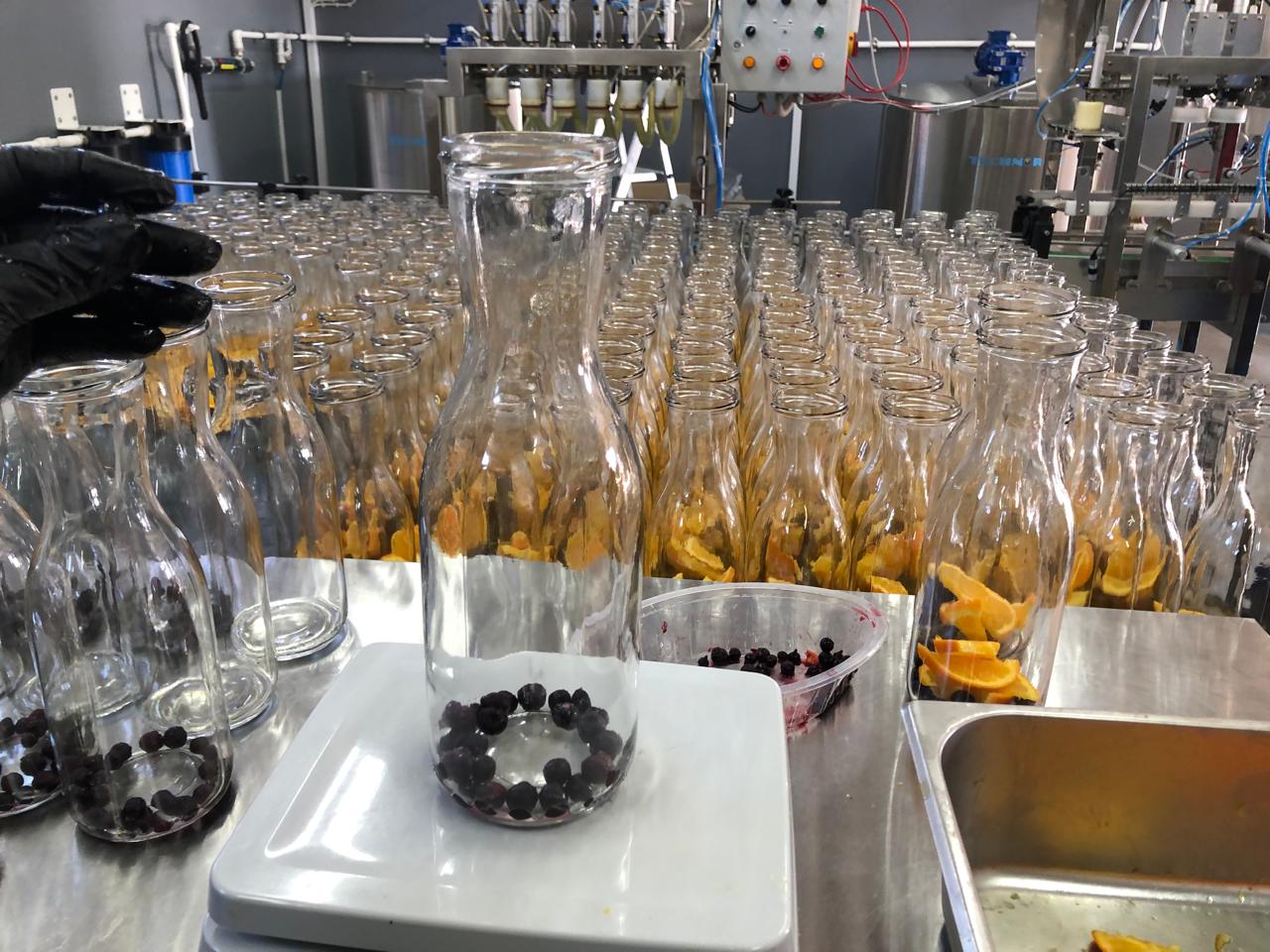 Black currants being portioned into bottles